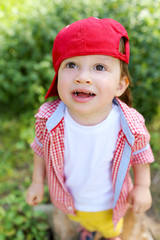 lovely baby standing on grass and looking up