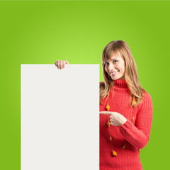 Woman with empty placard over green background