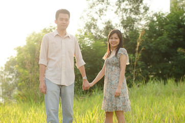 Fototapeta na wymiar chinese young couple on green grassland