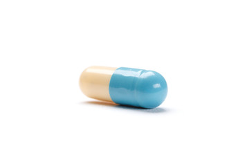 Blue and white capsule, isolated. Healthcare concept