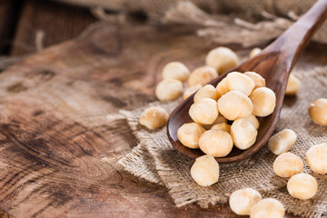 Fototapeta na wymiar Wooden spoon with Macadamia nuts