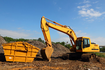 Yellow Excavator at Conmposting Site