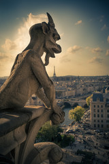 Ominous Notre Dame gargoyle over Paris
