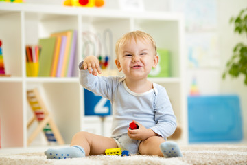 child boy playing with toys indoor