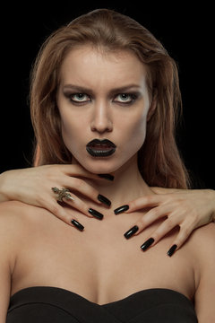 Pretty gothic woman with hands of vampire on her neck