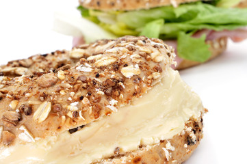 brown bagel filled with cheese spread