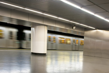 Moving subway train at station