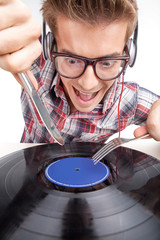Young man working as dj with ear-phones and glasses.