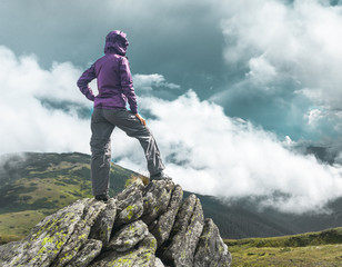 Woman on top of a mountain