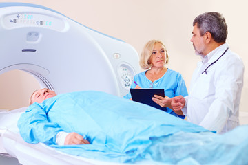 doctor instructing medical staff about CT scanner procedure