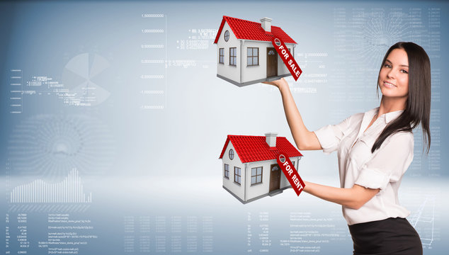 Businesswoman holding housees in hands