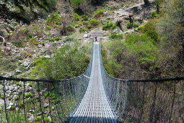 Suspension bridge. Annapurna Circuit - turists trek in Himalayas