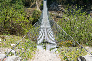 Suspension bridge. Annapurna Circuit - turists trek in Himalayas