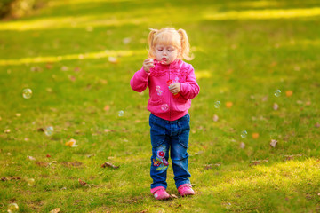 Happy girl with soap bubbles in the park. play, run, active