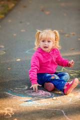 Fototapeta premium happy children draw with crayons on the pavement in the park
