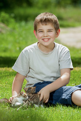 Happy little boy with a little cat