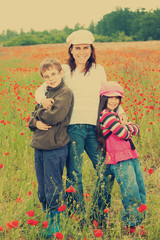 Vintage family on the poppy meadow