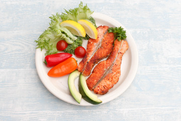 Grilled red fish medallions with vegetables