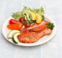 Grilled red fish medallions with vegetables