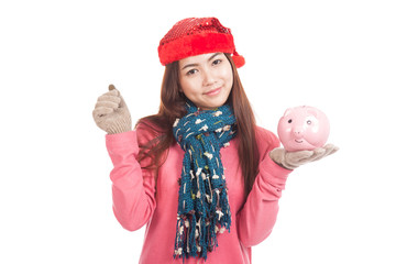 Asian girl with red christmas hat ,coin and piggy bank