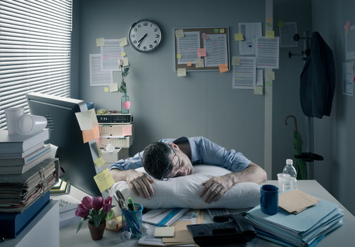 Businessman sleeping in the office overnight