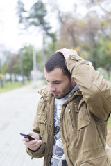 MAn upset looking at his phone