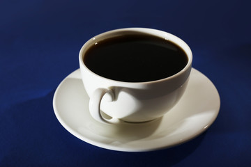 Cup of coffee on blue background