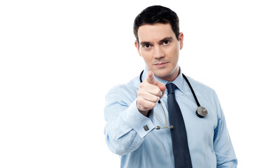 Middle aged doctor pointing at camera