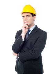 Thoughtful architect wearing a hard hat