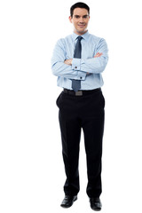 Smiling businessman with arms crossed