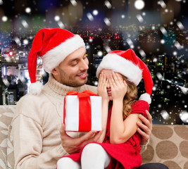 smiling daughter waiting for present from father