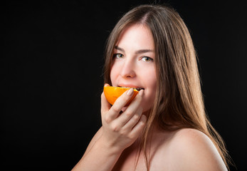 beautiful glad woman and fresh juicy orange