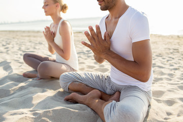 close up of couple making yoga exercises outdoors
