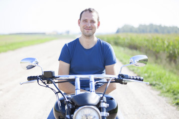 Young man on a motorcycle on a sunny day
