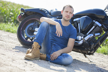 Fototapeta na wymiar Young man on a motorcycle on a sunny day