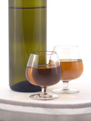 Glasses with wine and bottle part isolated on white