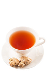 Ginger root and a cup of tea over white background