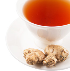 Ginger root and a cup of tea over white background