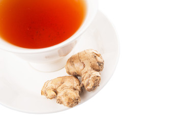 Ginger root and a cup of tea over white background