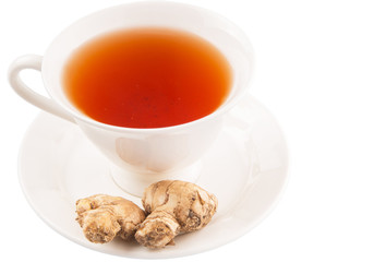 Ginger root and a cup of tea over white background