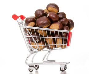 Shopping cart full of chestnuts, isolated on white background