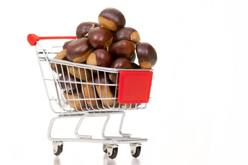 Shopping cart full of chestnuts, isolated on white background