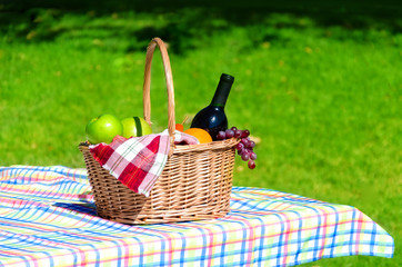 Picnic basket with fruits and wine