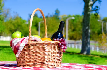 Picnic basket with fruits and wine