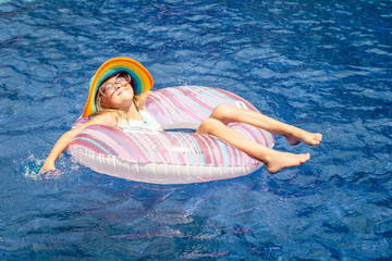 little girl  lying on the  inflatable rubber circle  in the swim