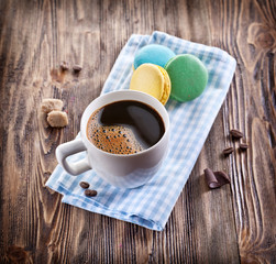 Cup of coffee and french macaron.