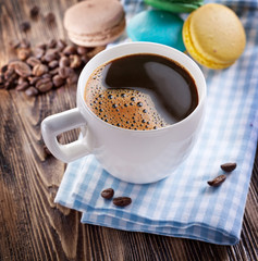 Cup of coffee and french macaron.