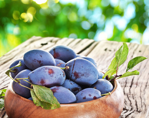 Plums on an old wooden table.