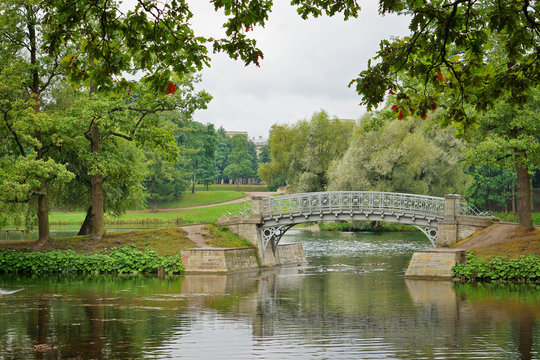 Metal bridge over flow in the palace park in Gatchina