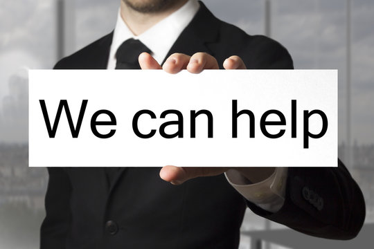 Businessman Showing Sign We Can Help